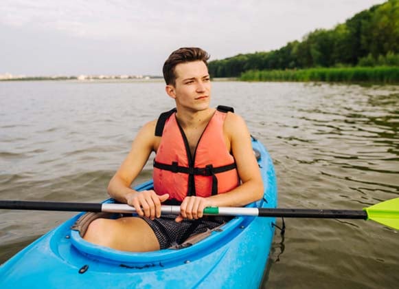 A person with a life vest kayaking
