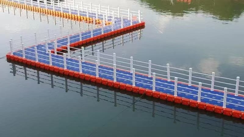 Blue and orange floating bridge with angled sections and white railings