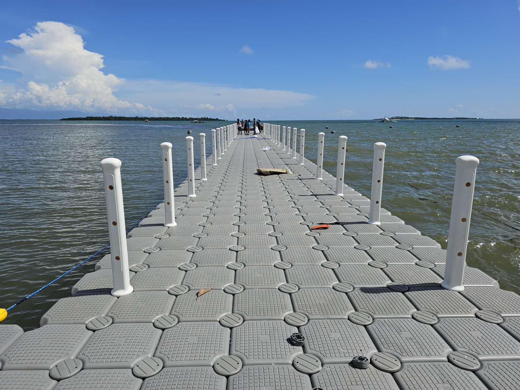 Grijze modulaire zwevende loopbrug met witte zijpalen
