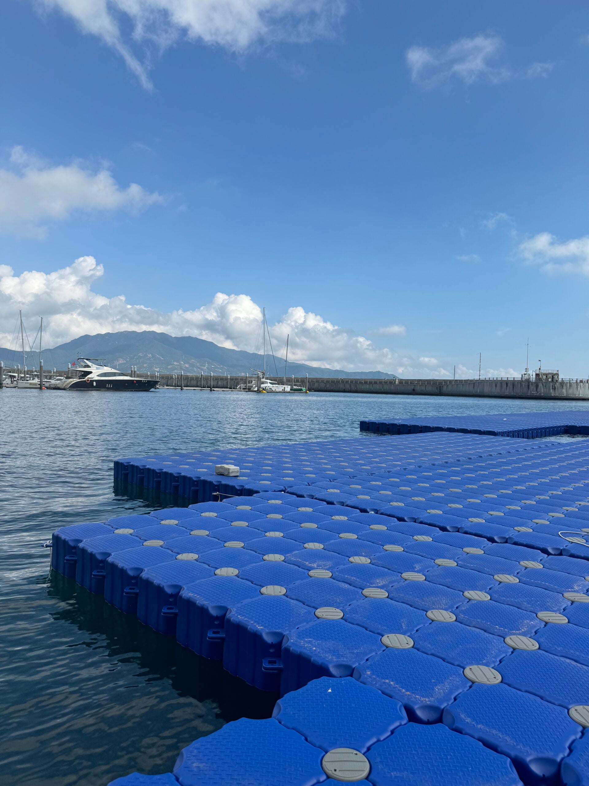 Exposed connection lugs along the edge of a blue floating platform